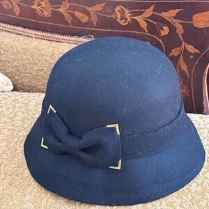 1920’s black wool cloche hat with metal-edged bow.